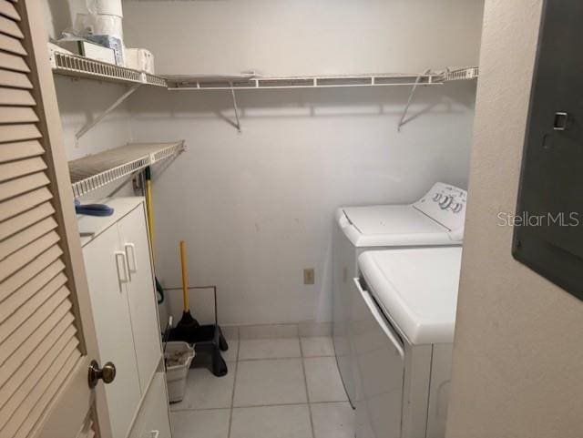 1258 Pine Ridge Cir W Unit F1, Tarpon Springs, FL 34688 - laundry area featuring washing machine and dryer and tile patterned flooring