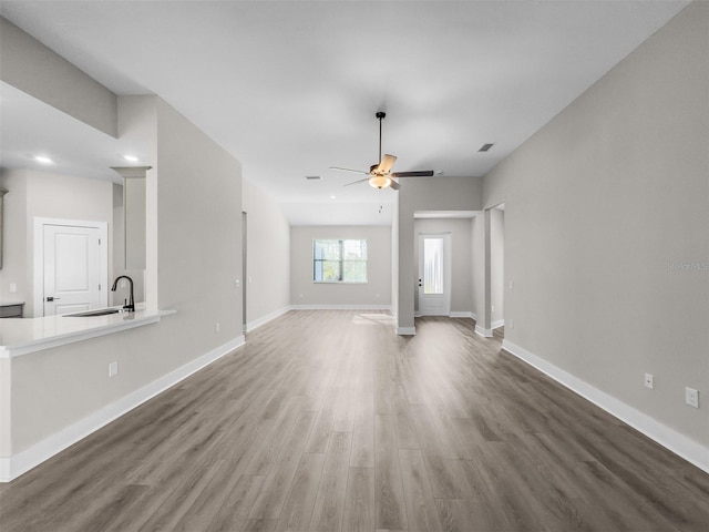 5104 Munhal St, Port Charlotte, FL 33981 - unfurnished living room featuring a sink, ceiling fan, wood finished floors, baseboards, and recessed lighting