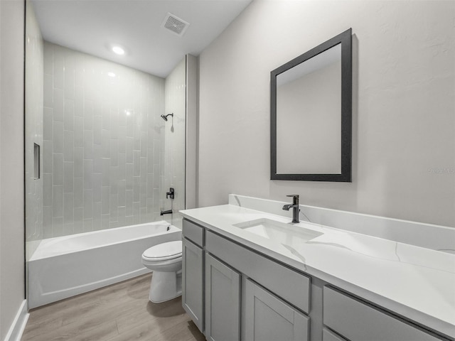5104 Munhal St, Port Charlotte, FL 33981 - bathroom featuring wood finished floors, toilet, vanity, and washtub / shower combination