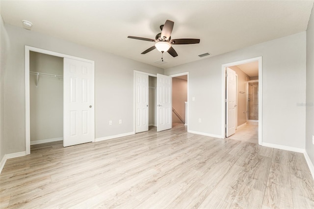 9140 Hillcroft Dr, Riverview, FL 33578 - unfurnished bedroom with two closets, light wood finished floors, ensuite bath, and baseboards