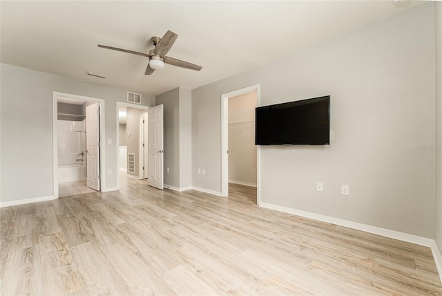9140 Hillcroft Dr, Riverview, FL 33578 - unfurnished bedroom featuring light wood-style floors, a spacious closet, baseboards, a closet, and ensuite bathroom