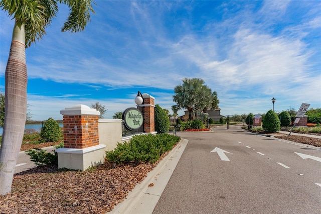 9140 Hillcroft Dr, Riverview, FL 33578 - view of asphalt road featuring street lighting, a gate, curbs, and a gated entry