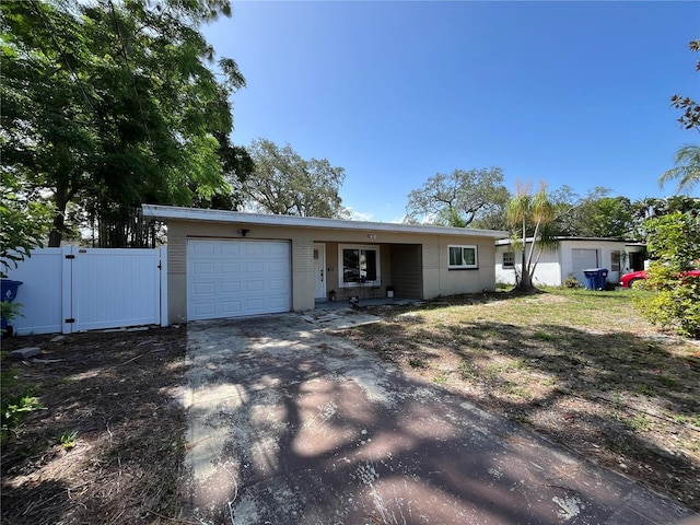 422 Crosswinds Dr, Palm Harbor, FL 34683 - view of front of property with driveway, a garage, and a gate