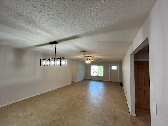 422 Crosswinds Dr, Palm Harbor, FL 34683 - empty room with ceiling fan, baseboards, a textured ceiling, and light tile patterned flooring