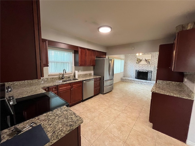 422 Crosswinds Dr, Palm Harbor, FL 34683 - kitchen with a sink, stainless steel appliances, a fireplace, light tile patterned flooring, and light stone countertops