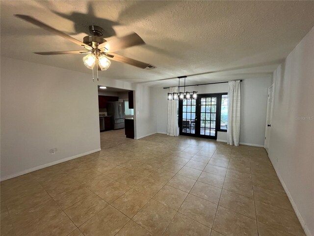 422 Crosswinds Dr, Palm Harbor, FL 34683 - unfurnished room featuring french doors, light tile patterned floors, ceiling fan, a textured ceiling, and baseboards