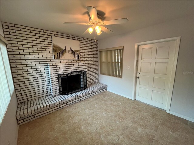 422 Crosswinds Dr, Palm Harbor, FL 34683 - unfurnished living room with ceiling fan, a brick fireplace, tile patterned floors, and baseboards
