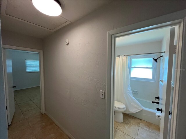 422 Crosswinds Dr, Palm Harbor, FL 34683 - hallway with light tile patterned floors, baseboards, and a textured wall