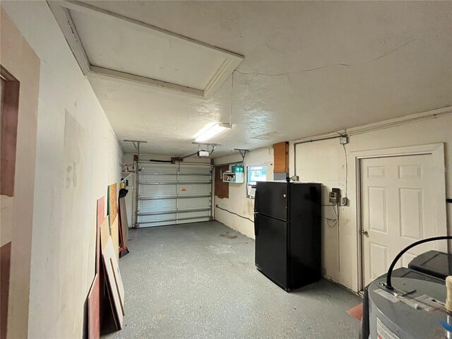 422 Crosswinds Dr, Palm Harbor, FL 34683 - garage featuring freestanding refrigerator and a garage door opener