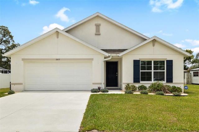 10452 Elgin Blvd, Spring Hill, FL 34608 - view of front of house with stucco siding, a garage, concrete driveway, and a front yard