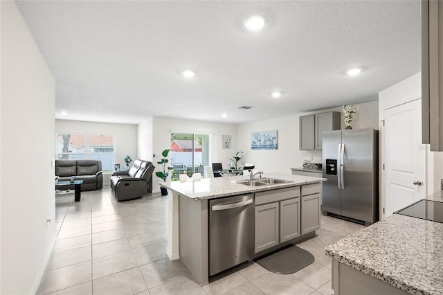 10452 Elgin Blvd, Spring Hill, FL 34608 - kitchen with stainless steel appliances, gray cabinetry, a sink, recessed lighting, and an island with sink