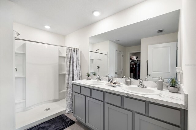 10452 Elgin Blvd, Spring Hill, FL 34608 - bathroom with a shower stall, a walk in closet, and double vanity