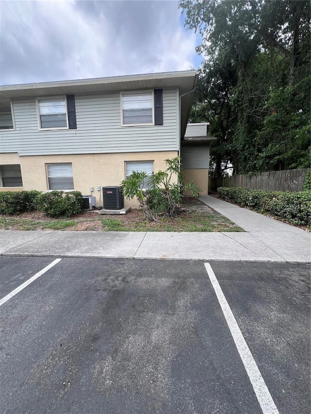 226 Thorn Tree Pl Unit 226, Brandon, FL 33510 - view of front facade featuring uncovered parking, central air condition unit, and stucco siding