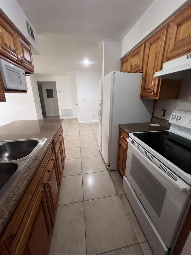 226 Thorn Tree Pl Unit 226, Brandon, FL 33510 - kitchen featuring white appliances, under cabinet range hood, and brown cabinetry