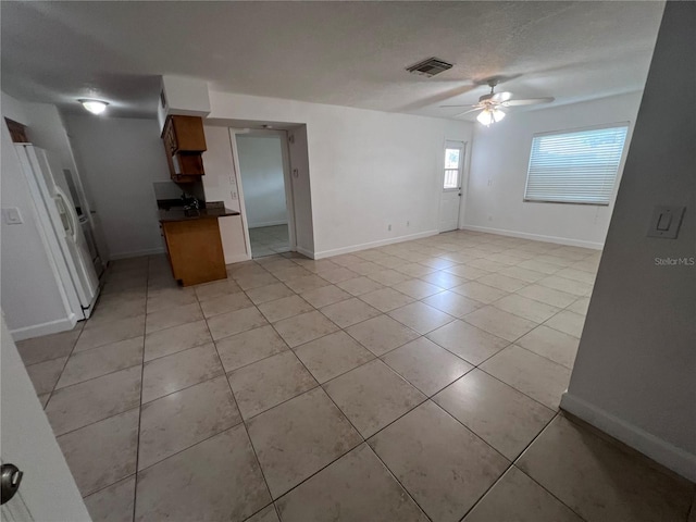 226 Thorn Tree Pl Unit 226, Brandon, FL 33510 - kitchen with a ceiling fan, white refrigerator with ice dispenser, dark countertops, open floor plan, and light tile patterned floors