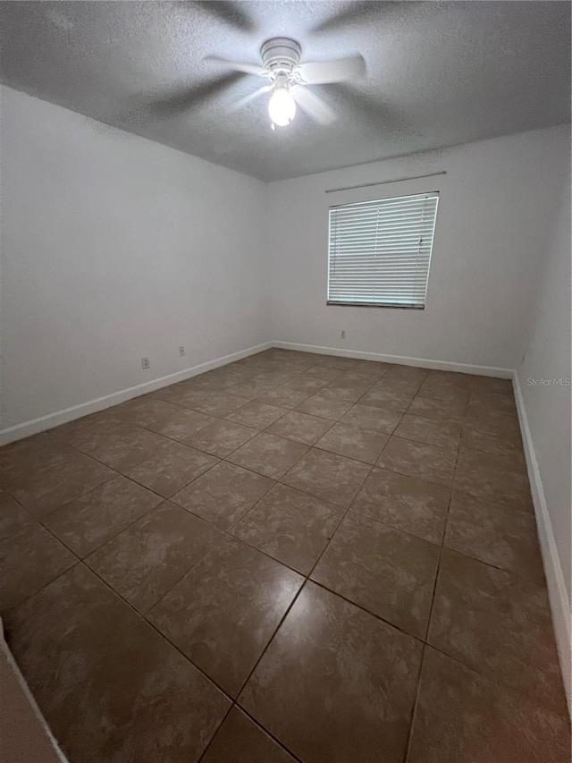 226 Thorn Tree Pl Unit 226, Brandon, FL 33510 - spare room with a textured ceiling, tile patterned floors, ceiling fan, and baseboards