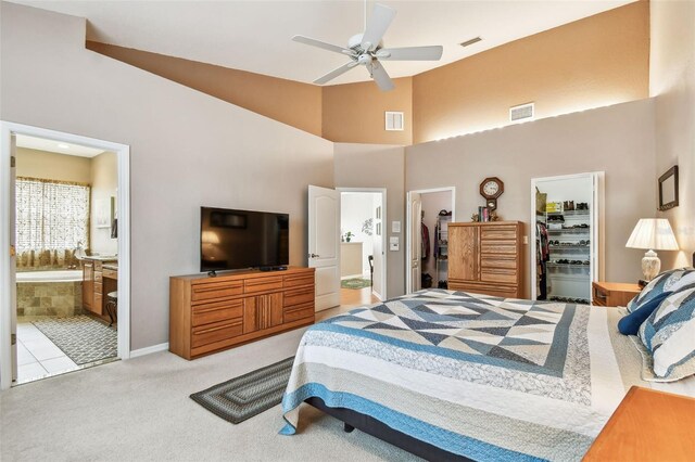 3484 Primrose Way, Palm Harbor, FL 34683 - carpeted bedroom featuring a walk in closet, high vaulted ceiling, ensuite bathroom, a closet, and a ceiling fan