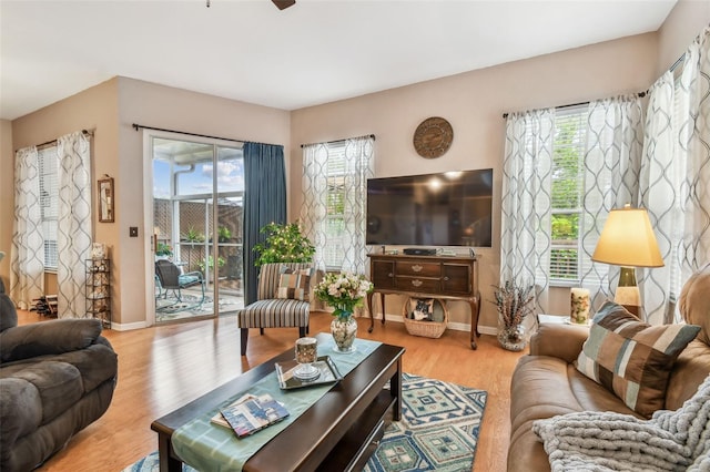 3484 Primrose Way, Palm Harbor, FL 34683 - living area featuring healthy amount of natural light, wood finished floors, and a ceiling fan