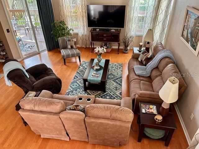 3484 Primrose Way, Palm Harbor, FL 34683 - living area featuring wood finished floors and baseboards