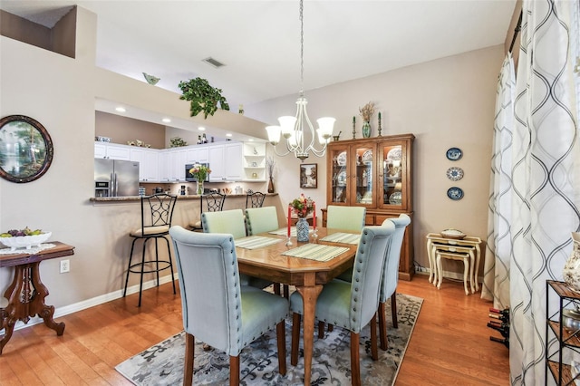 3484 Primrose Way, Palm Harbor, FL 34683 - dining area with a chandelier, light wood-type flooring, recessed lighting, and lofted ceiling
