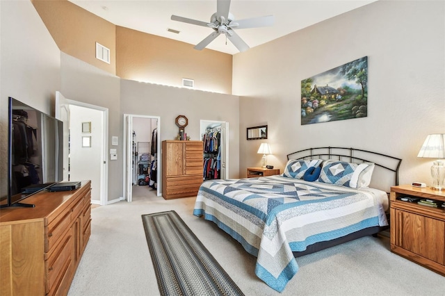 3484 Primrose Way, Palm Harbor, FL 34683 - bedroom featuring light carpet, a towering ceiling, a spacious closet, a closet, and ceiling fan