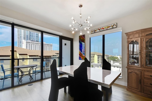 199 Dali Blvd Unit 607, Saint Petersburg, FL 33701 - dining room with a chandelier, plenty of natural light, light wood-style floors, and a view of city