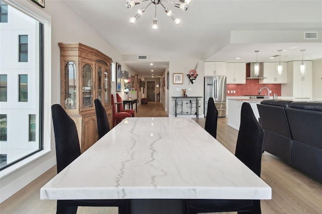 199 Dali Blvd Unit 607, Saint Petersburg, FL 33701 - dining room with light wood-style flooring and a chandelier