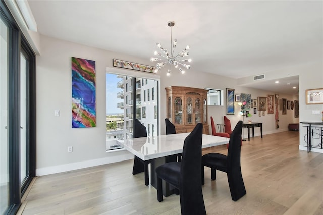 199 Dali Blvd Unit 607, Saint Petersburg, FL 33701 - dining room with a chandelier, baseboards, light wood-type flooring, and recessed lighting