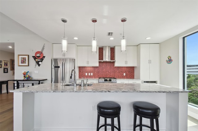 199 Dali Blvd Unit 607, Saint Petersburg, FL 33701 - kitchen featuring wall chimney exhaust hood, stainless steel appliances, a sink, decorative backsplash, and plenty of natural light