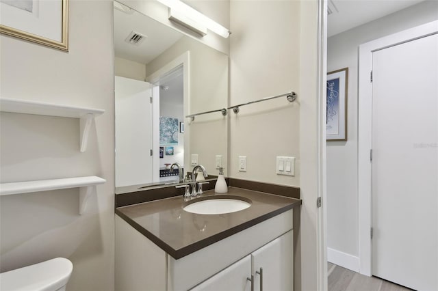 199 Dali Blvd Unit 607, Saint Petersburg, FL 33701 - half bath featuring vanity, toilet, and wood finished floors