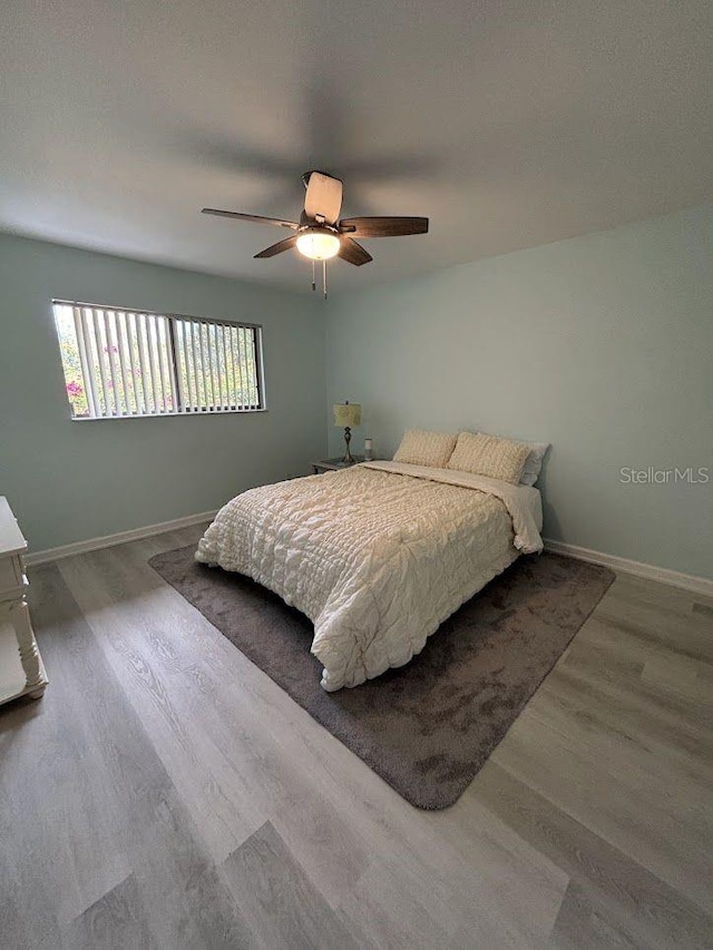 1055 6th Ave Unit A11, Vero Beach, FL 32960 - bedroom with wood finished floors, baseboards, and ceiling fan
