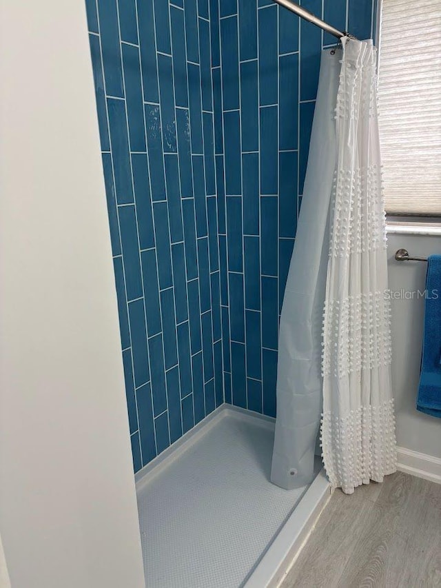 1055 6th Ave Unit A11, Vero Beach, FL 32960 - bathroom with a tile shower and wood finished floors