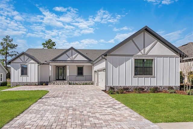 4799 Hickory Oak Loop, Brooksville, FL 34601 - english style home featuring board and batten siding, an attached garage, decorative driveway, and a front lawn