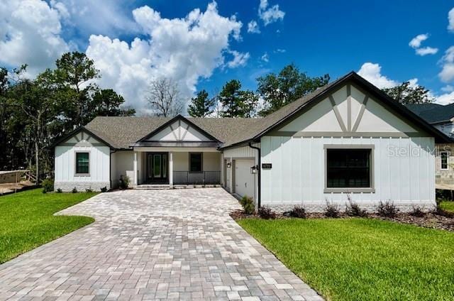4799 Hickory Oak Loop, Brooksville, FL 34601 - view of front facade with decorative driveway, a garage, and a front lawn