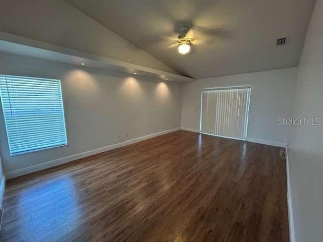 2635 Jarvis Cir, Palm Harbor, FL 34683 - unfurnished room with lofted ceiling, dark wood finished floors, baseboards, and ceiling fan