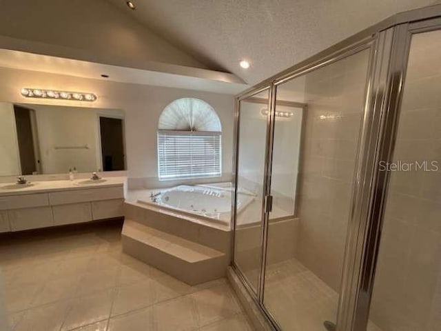 2635 Jarvis Cir, Palm Harbor, FL 34683 - full bath with vaulted ceiling, a garden tub, double vanity, a stall shower, and tile patterned flooring