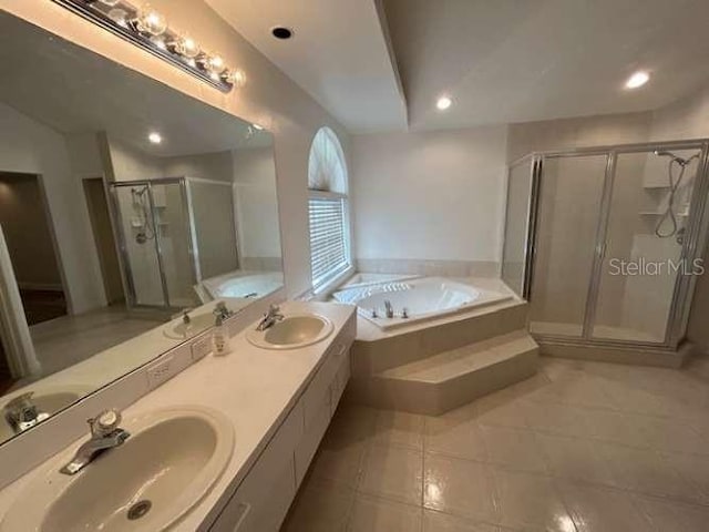 2635 Jarvis Cir, Palm Harbor, FL 34683 - full bath with tile patterned floors, a shower stall, a garden tub, double vanity, and recessed lighting