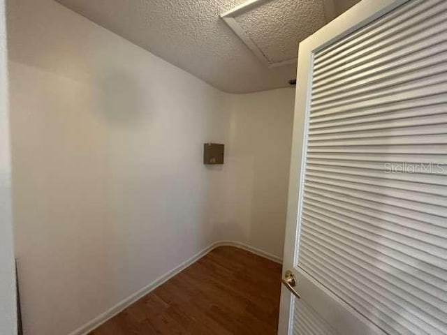 2635 Jarvis Cir, Palm Harbor, FL 34683 - walk in closet featuring wood finished floors and attic access
