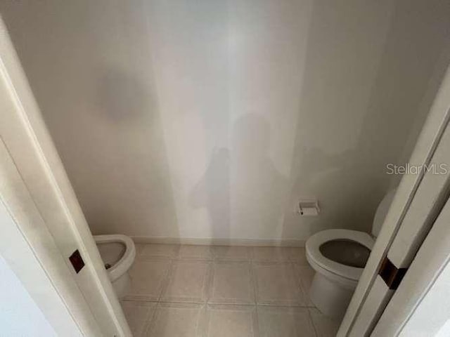 2635 Jarvis Cir, Palm Harbor, FL 34683 - bathroom with toilet, tile patterned floors, and baseboards