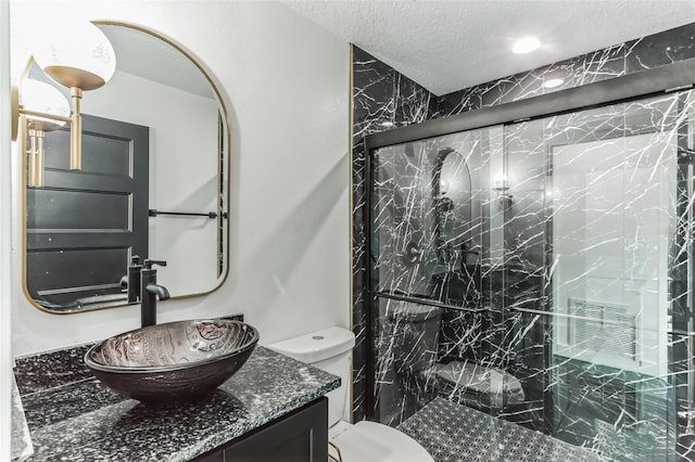 2010 4th Ave W, Palmetto, FL 34221 - bathroom with vanity, a marble finish shower, toilet, and a textured ceiling