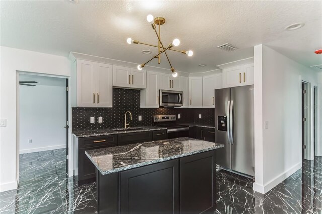 2010 4th Ave W, Palmetto, FL 34221 - kitchen with appliances with stainless steel finishes, a sink, dark marble finish floors, baseboards, and a textured ceiling