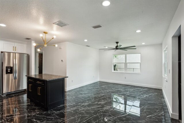 2010 4th Ave W, Palmetto, FL 34221 - kitchen featuring stainless steel fridge, dark marble finish floors, a chandelier, dark stone countertops, and recessed lighting
