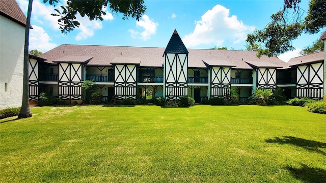 230 N Bayshore Blvd Unit 103, Clearwater, FL 33759 - rear view of house featuring a yard and a shingled roof