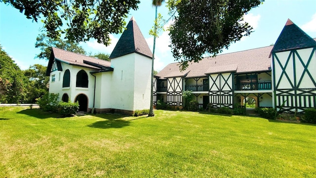 230 N Bayshore Blvd Unit 103, Clearwater, FL 33759 - back of property with stucco siding, a yard, and roof with shingles