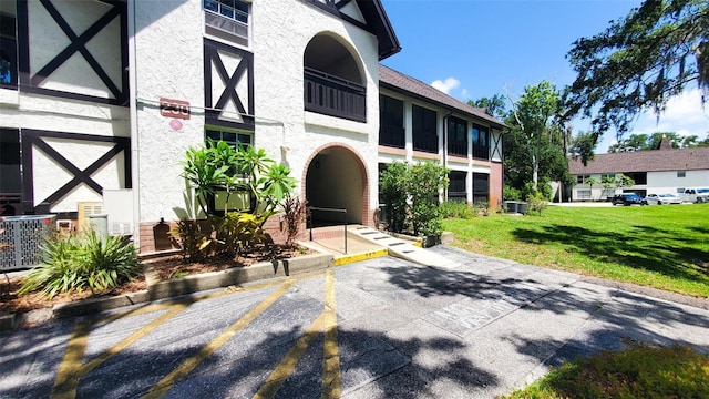 230 N Bayshore Blvd Unit 103, Clearwater, FL 33759 - view of property with uncovered parking and central AC