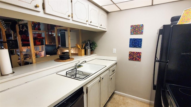 230 N Bayshore Blvd Unit 103, Clearwater, FL 33759 - kitchen featuring a sink, baseboards, light countertops, and white cabinets