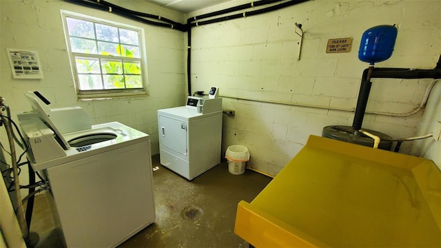 230 N Bayshore Blvd Unit 103, Clearwater, FL 33759 - washroom featuring washing machine and dryer and concrete block wall