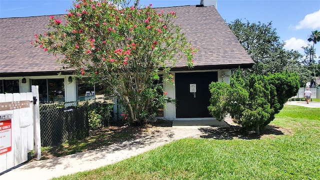 230 N Bayshore Blvd Unit 103, Clearwater, FL 33759 - view of front of home with a shingled roof and a front lawn