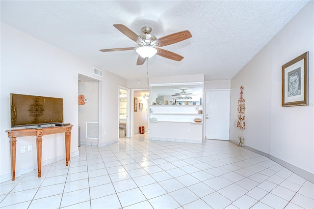 1655 S Highland Ave Unit B118, Clearwater, FL 33756 - unfurnished living room featuring ceiling fan, a textured ceiling, and light tile patterned flooring