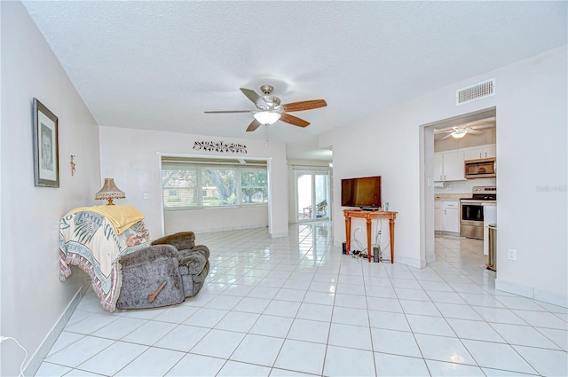 1655 S Highland Ave Unit B118, Clearwater, FL 33756 - living room with a ceiling fan, light tile patterned floors, and a textured ceiling